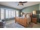 Cozy bedroom with a wooden bed frame, plush rug, and ample natural light from a window at 13913 W Whitewood Dr, Sun City West, AZ 85375