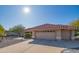 Charming home featuring a red tile roof, a two-car garage, and mature landscaping at 13913 W Whitewood Dr, Sun City West, AZ 85375