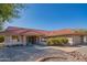 Inviting single-story home featuring a clay tile roof, manicured shrubs, and charming curb appeal at 13913 W Whitewood Dr, Sun City West, AZ 85375