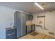 Spacious garage featuring ample storage cabinets and a convenient utility sink at 13913 W Whitewood Dr, Sun City West, AZ 85375
