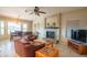 Comfortable living room area with fireplace, tile flooring and views to dining room at 13913 W Whitewood Dr, Sun City West, AZ 85375