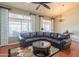 Spacious living room with a plush sectional sofa and large windows at 13913 W Whitewood Dr, Sun City West, AZ 85375