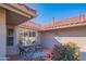 Relaxing covered patio with comfortable seating and views of colorful flowers and greenery at 13913 W Whitewood Dr, Sun City West, AZ 85375