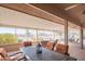 Covered patio with comfortable seating area and neighborhood views at 13913 W Whitewood Dr, Sun City West, AZ 85375