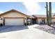 Beautiful tan home with a two car garage and a red tile roof in a desert landscape at 15445 E Thistle Dr, Fountain Hills, AZ 85268