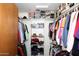 Well organized walk-in closet with multiple shelves, clothing racks, and hanging clothes at 15445 E Thistle Dr, Fountain Hills, AZ 85268