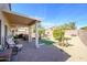 Inviting backyard with brick pavers, covered patio, mature landscaping, and privacy fence at 15770 W Remington Dr, Surprise, AZ 85374