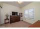 Cozy bedroom with a window with blinds, and a dark wood dresser, with a neutral carpet at 15770 W Remington Dr, Surprise, AZ 85374