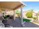 Inviting covered patio with brick pavers, seating, and desert landscaping at 15770 W Remington Dr, Surprise, AZ 85374