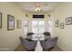 Bright dining area with a glass table, comfortable chairs, and large windows with plantation shutters at 15770 W Remington Dr, Surprise, AZ 85374