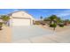 Charming single Gathering home with a two car garage, low maintenance desert landscaping and an American flag at 15770 W Remington Dr, Surprise, AZ 85374