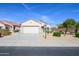 Charming single-story home features a well-maintained desert landscape and a two-car garage at 15770 W Remington Dr, Surprise, AZ 85374