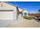 Inviting facade of a single-story home featuring a well-manicured lawn and a convenient two-car garage at 15770 W Remington Dr, Surprise, AZ 85374