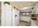 Charming kitchen featuring white cabinets, tile countertops, and stainless-steel appliances at 15770 W Remington Dr, Surprise, AZ 85374