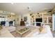 Bright living room with a large sectional, breakfast bar, custom shelving, and an open floor plan at 15770 W Remington Dr, Surprise, AZ 85374