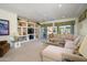 Bright living room with a large sectional sofa, custom built-ins, and sliding glass doors to the backyard at 15770 W Remington Dr, Surprise, AZ 85374