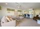 Spacious living room with a comfortable sectional sofa, breakfast bar, and view to the kitchen at 15770 W Remington Dr, Surprise, AZ 85374