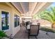 Inviting covered patio with stone pavers, ideal for outdoor dining and entertaining, with desert landscape at 15770 W Remington Dr, Surprise, AZ 85374