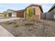 Low maintenance xeriscape landscaping with accent stones and small plants complement this charming single story home at 16020 W Hackamore Dr, Surprise, AZ 85387