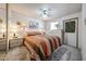 Cozy bedroom featuring a queen bed with lamps, dresser, ceiling fan, and closet at 17200 W Bell Rd # 2162, Surprise, AZ 85374