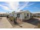 Charming single-story home featuring a well-maintained yard and appealing curb appeal under a partly cloudy sky at 17200 W Bell Rd # 2162, Surprise, AZ 85374