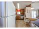 Traditional kitchen featuring appliances, tile flooring, and a breakfast nook with backyard access at 17200 W Bell Rd # 2162, Surprise, AZ 85374