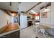 Functional kitchen featuring appliances, tile flooring, and a breakfast nook at 17200 W Bell Rd # 2162, Surprise, AZ 85374