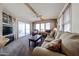 Inviting living room with a cozy seating arrangement, natural light, fireplace and sliding glass doors at 17200 W Bell Rd # 2162, Surprise, AZ 85374