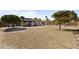 Expansive backyard with a large gravel area, mature trees, patio, and privacy fence at 17410 N Conquistador Dr, Sun City West, AZ 85375