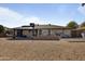 Large backyard featuring a covered patio, gravel landscaping, and a barbeque grill at 17410 N Conquistador Dr, Sun City West, AZ 85375