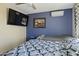 Cozy bedroom with a blue accent wall, ceiling fan, and a comfortable bed at 17410 N Conquistador Dr, Sun City West, AZ 85375