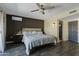 Well-lit bedroom featuring modern decor, an ensuite bathroom, and a ceiling fan at 17410 N Conquistador Dr, Sun City West, AZ 85375