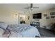 Comfortable bedroom with stylish decor, a ceiling fan, television, and access to an ensuite bathroom at 17410 N Conquistador Dr, Sun City West, AZ 85375