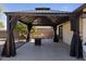 Backyard covered patio with a fire pit and outdoor seating at 17410 N Conquistador Dr, Sun City West, AZ 85375