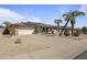 Charming brick home with a two-car garage, long driveway, desert landscaping and solar panels at 17410 N Conquistador Dr, Sun City West, AZ 85375