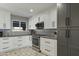 Well-lit kitchen featuring white cabinetry, stainless steel appliances, and a tile backsplash at 17410 N Conquistador Dr, Sun City West, AZ 85375