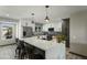 Modern kitchen with a large center island, stainless steel appliances, and elegant pendant lighting at 17410 N Conquistador Dr, Sun City West, AZ 85375