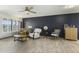 Inviting living room with a ceiling fan, wood-look floors, and a large window with shutters at 17410 N Conquistador Dr, Sun City West, AZ 85375