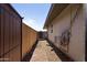 Side yard with gravel landscaping and an air conditioning unit at 17410 N Conquistador Dr, Sun City West, AZ 85375