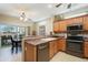 Well-equipped kitchen with stainless steel appliances, ample cabinetry, and a view of the outdoor dining space at 17571 N Saddle Ridge Dr, Surprise, AZ 85374