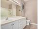 Bright bathroom with white cabinets, a large mirror, and a glass-enclosed shower at 17815 W Calistoga Dr, Surprise, AZ 85387