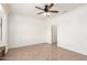 Bright bedroom with a ceiling fan, neutral walls, and tile floors at 17815 W Calistoga Dr, Surprise, AZ 85387
