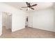 Spacious bedroom features neutral walls, ceiling fan, and tile flooring at 17815 W Calistoga Dr, Surprise, AZ 85387