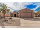 Exterior of a single-story home featuring a desert landscape, a two car garage, and a tile roof at 17815 W Calistoga Dr, Surprise, AZ 85387