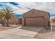 Charming single-story home with a two-car garage and xeriscaping in the front yard at 17815 W Calistoga Dr, Surprise, AZ 85387