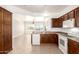 Traditional kitchen featuring wood cabinets, white appliances, and neutral countertops at 17815 W Calistoga Dr, Surprise, AZ 85387