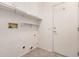 Utility room featuring tile flooring, shelving, and hookups for laundry appliances at 17815 W Calistoga Dr, Surprise, AZ 85387