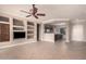 Spacious living room featuring tile floors, a ceiling fan, and open access to the kitchen at 17815 W Calistoga Dr, Surprise, AZ 85387