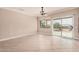 Open living area with tile flooring, a ceiling fan, built-in shelving, and sliding glass doors to the backyard at 17815 W Calistoga Dr, Surprise, AZ 85387