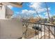 A balcony with metal railings overlooks a street with trees, offering a charming outdoor space at 18239 N 40Th St # 107, Phoenix, AZ 85032